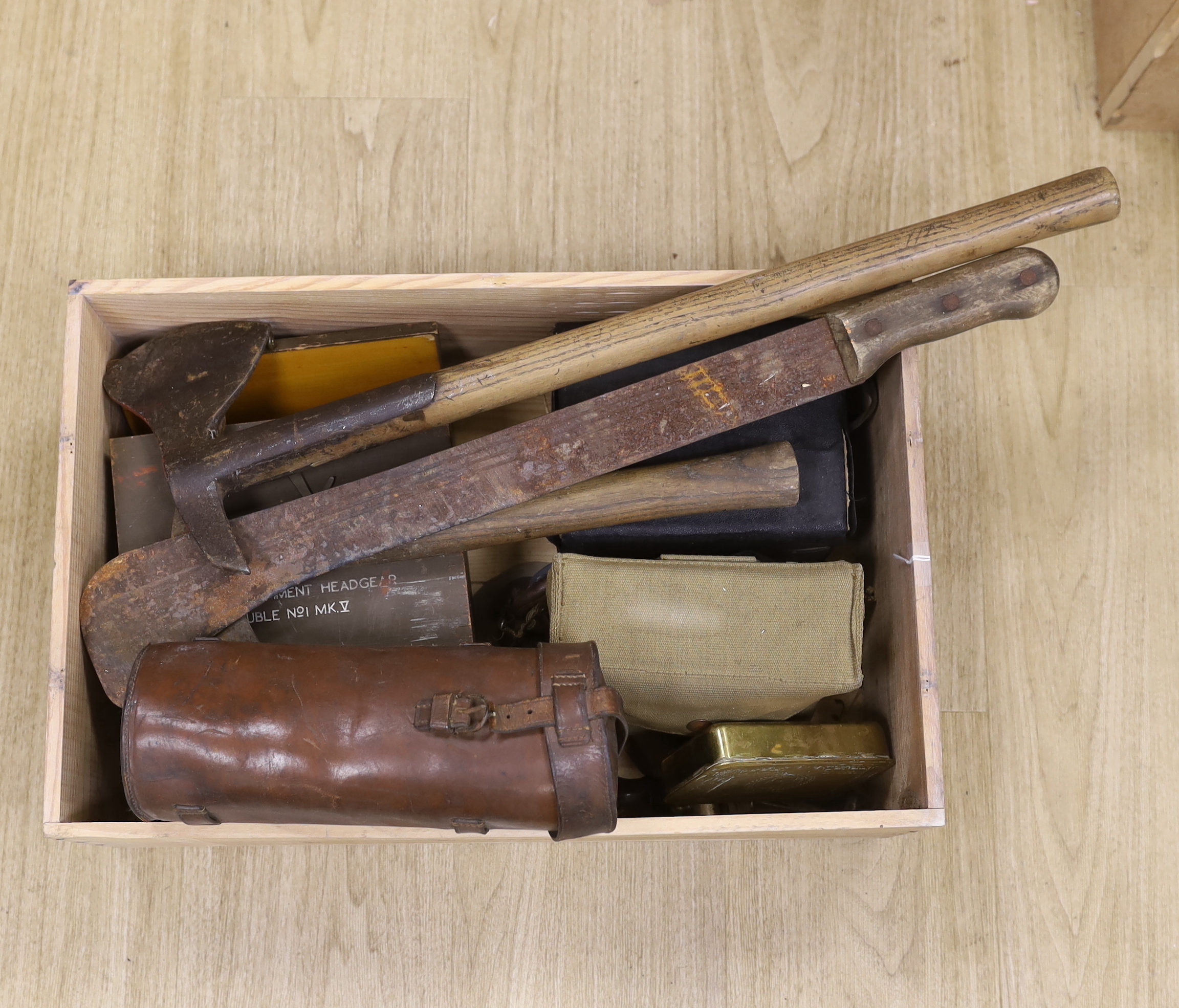 A quantity of militaria including a US Marine Corps penknife, another penknife, a pair of tank driver’s goggles, a Queen Mary Christmas tin, a box for a telephone attachment headgear, a truncheon, two hand axes, etc